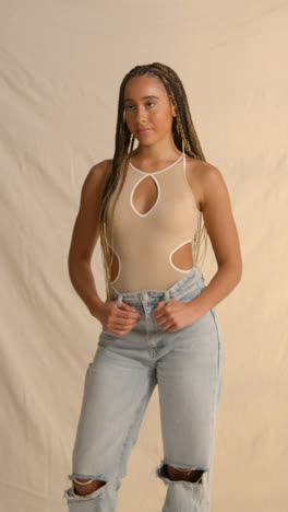 Studio-Portrait-Shot-Of-Young-Woman-With-Long-Braided-Hair-Against-Neutral-Background-2